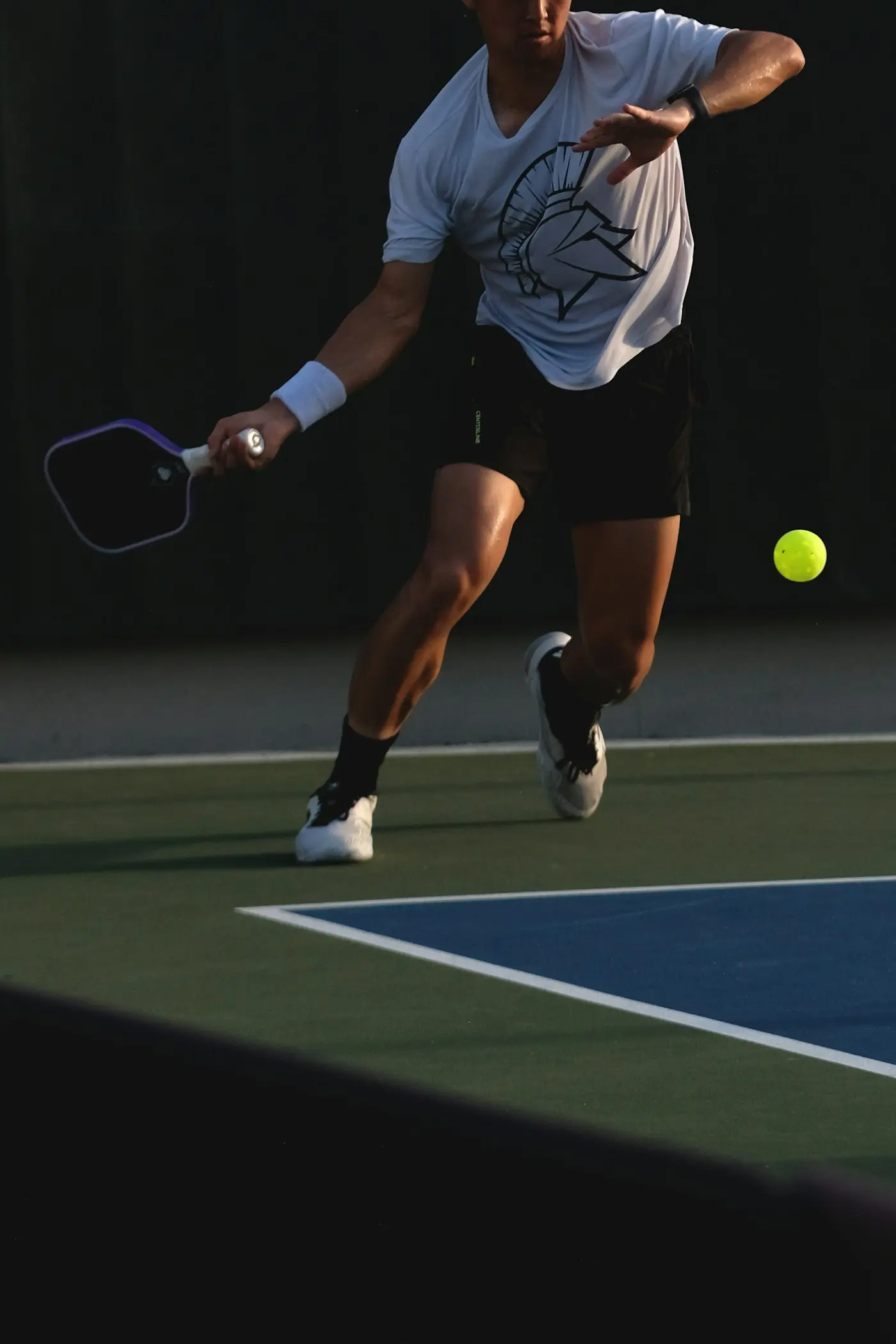 Player returning a volley on a pickleball court