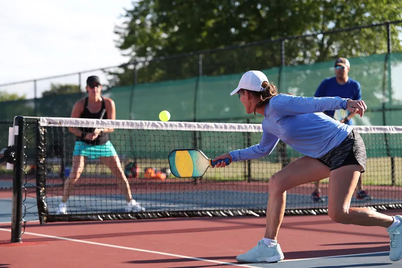 Aerial view of two outdoor pickleball courts with blue and green playing surfaces